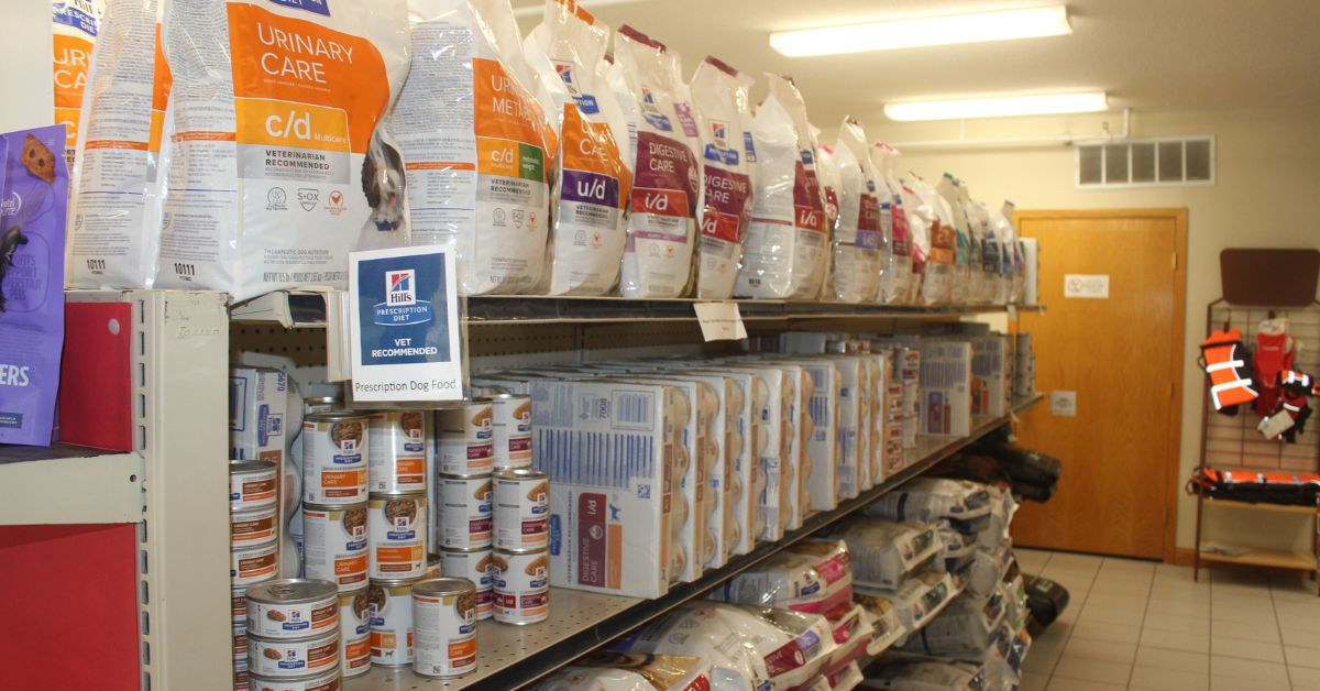 A long aisle in a supply room with shelves of canned goods