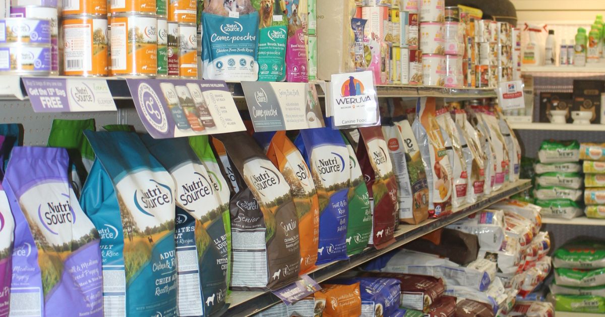 Inside a grocery store aisle with shelves of packaged food and drinks